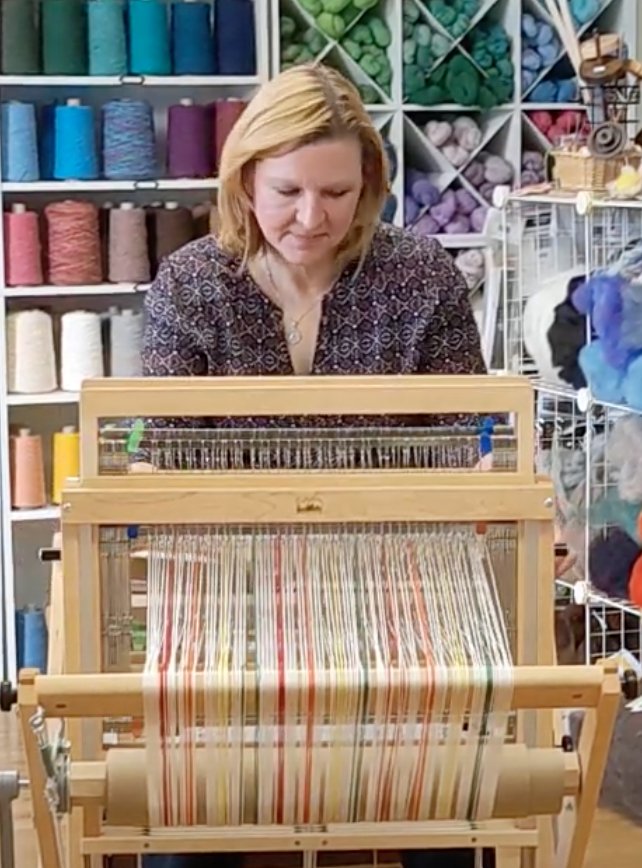 Cynthia Rice, owner of Sunshine Weaving and Fiber Arts, at her loom in the front room of her store.